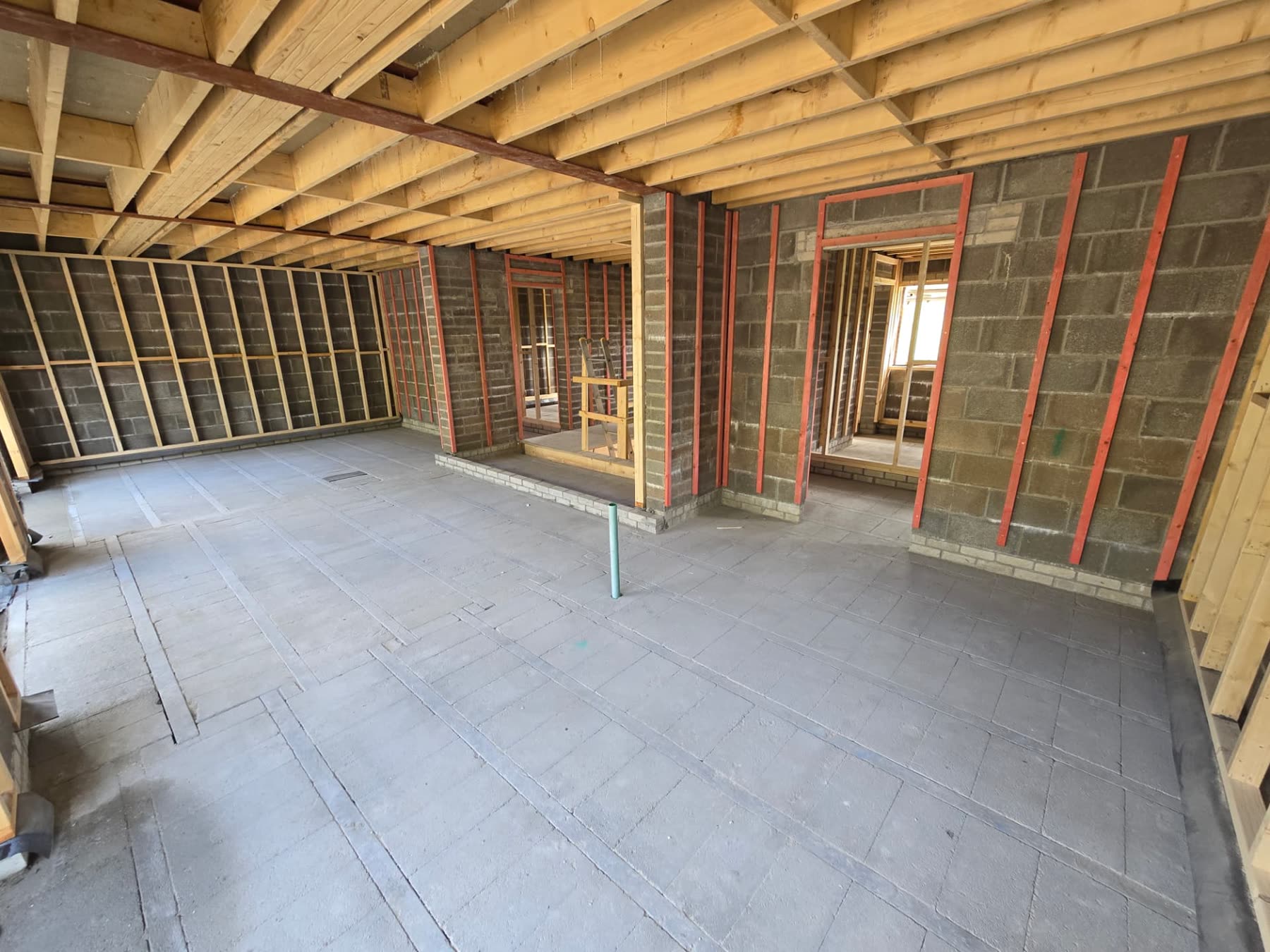 Solar panels installed across a tiled roof photographed from the scaffold