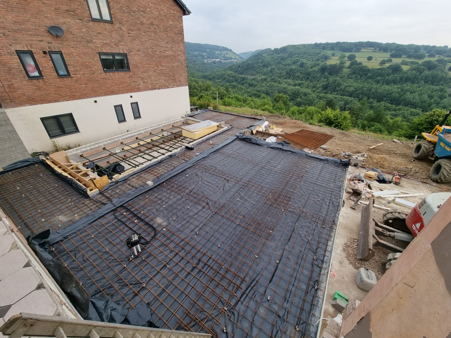 Reinforced concrete slab and retaining works on a sloping valley site in South Wales