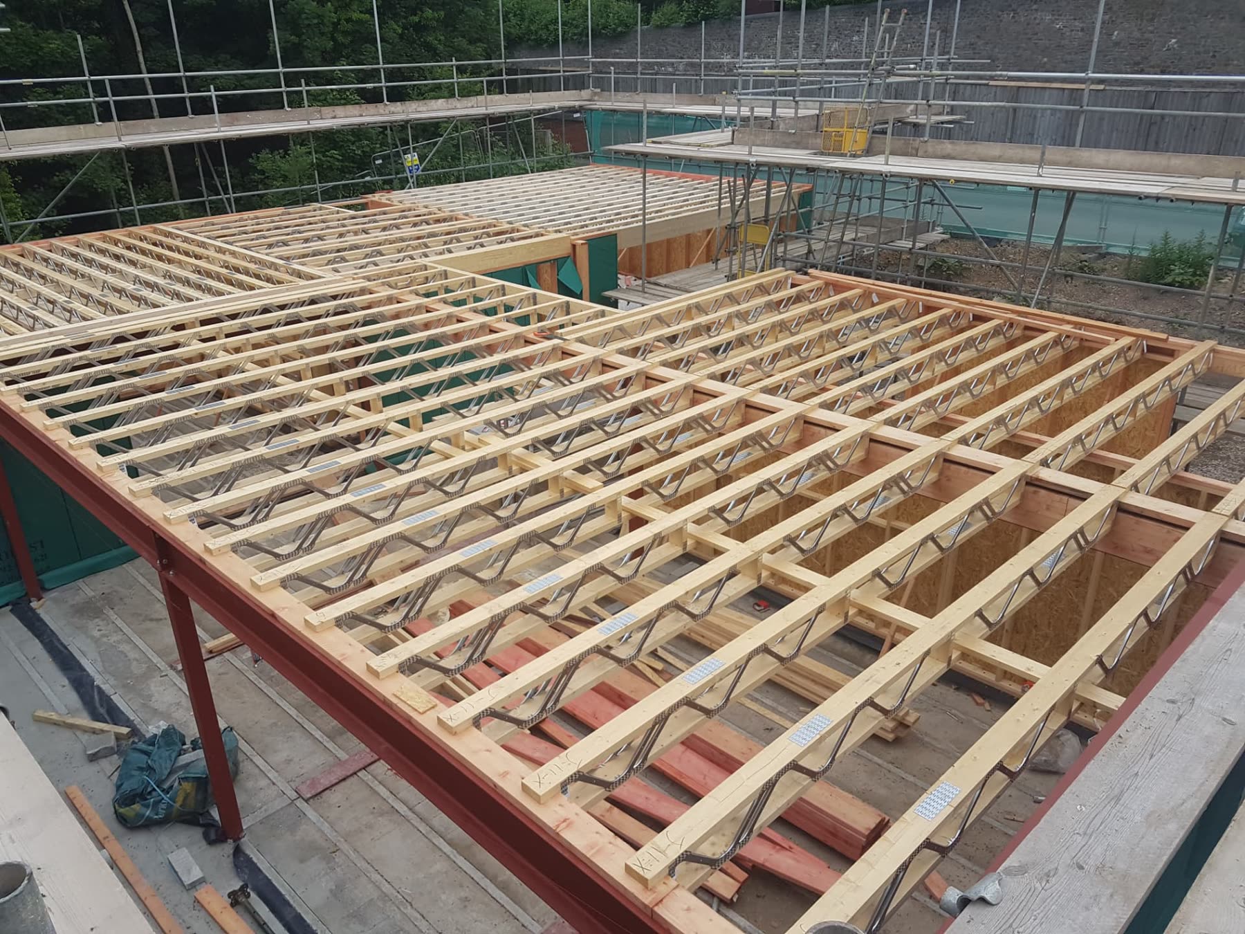 Steel beams and floor joists installed at first-floor level on a bespoke new build